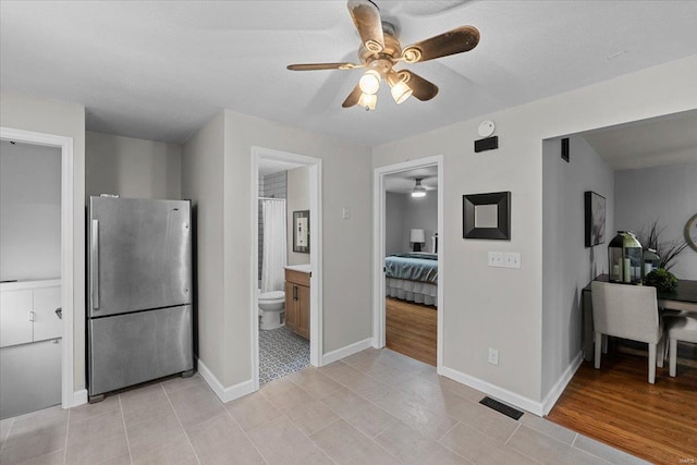 kitchen featuring stainless steel refrigerator and ceiling fan