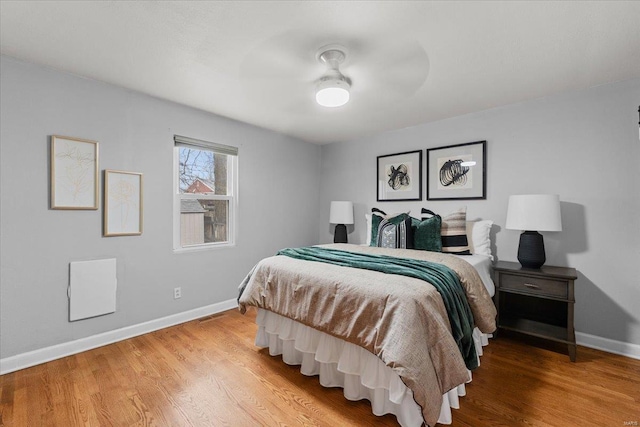 bedroom with hardwood / wood-style flooring and ceiling fan