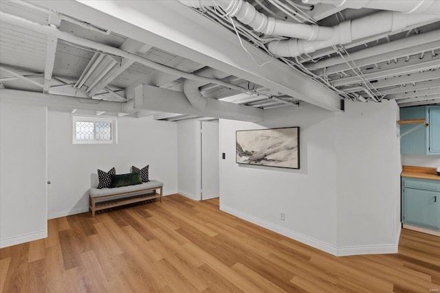 basement with hardwood / wood-style flooring