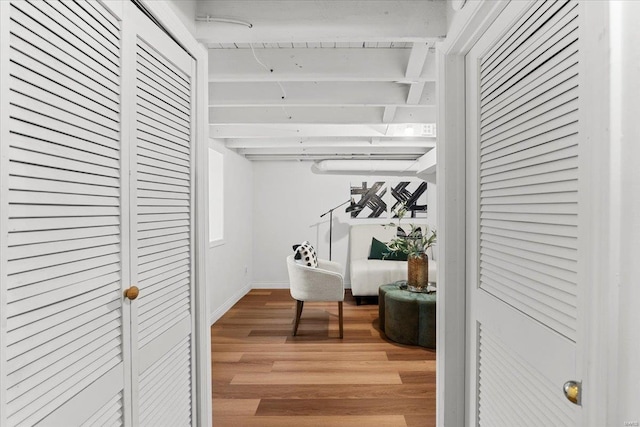 hall featuring beamed ceiling and hardwood / wood-style floors