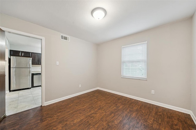 spare room featuring wood-type flooring