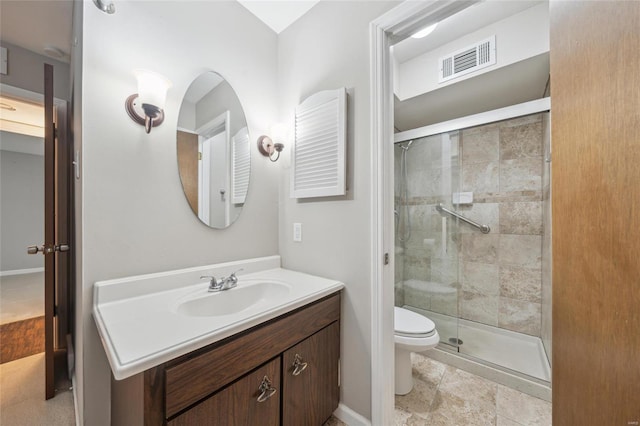 bathroom featuring vanity, a shower with door, and toilet