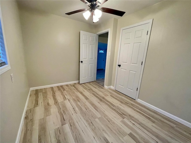 unfurnished bedroom with a closet, ceiling fan, and light wood-type flooring