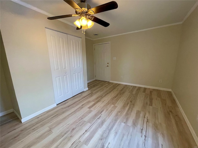 unfurnished bedroom with light wood-style flooring, baseboards, and ornamental molding