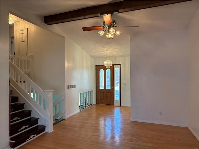 foyer featuring ceiling fan with notable chandelier, lofted ceiling with beams, and light hardwood / wood-style floors