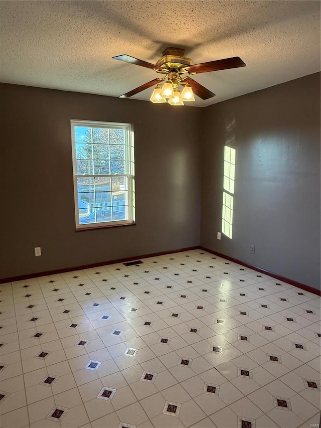 empty room featuring a textured ceiling and ceiling fan