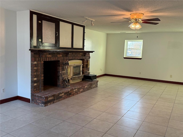 unfurnished living room with track lighting, light tile patterned floors, a textured ceiling, and a fireplace