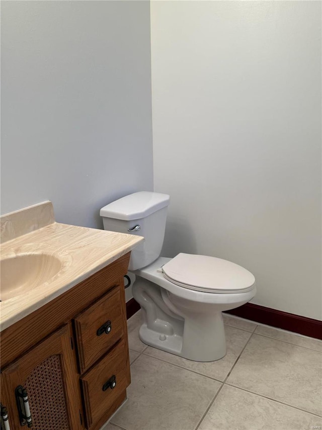 bathroom featuring tile patterned floors, vanity, and toilet