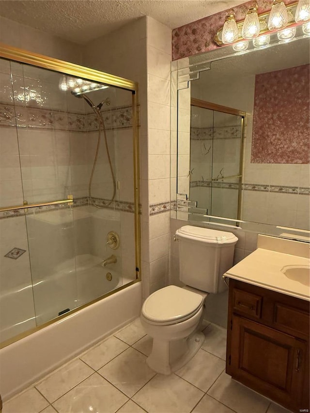 full bathroom with toilet, tile walls, a textured ceiling, enclosed tub / shower combo, and tile patterned flooring