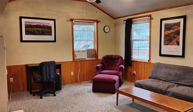 living area with lofted ceiling, crown molding, cooling unit, wooden walls, and carpet flooring