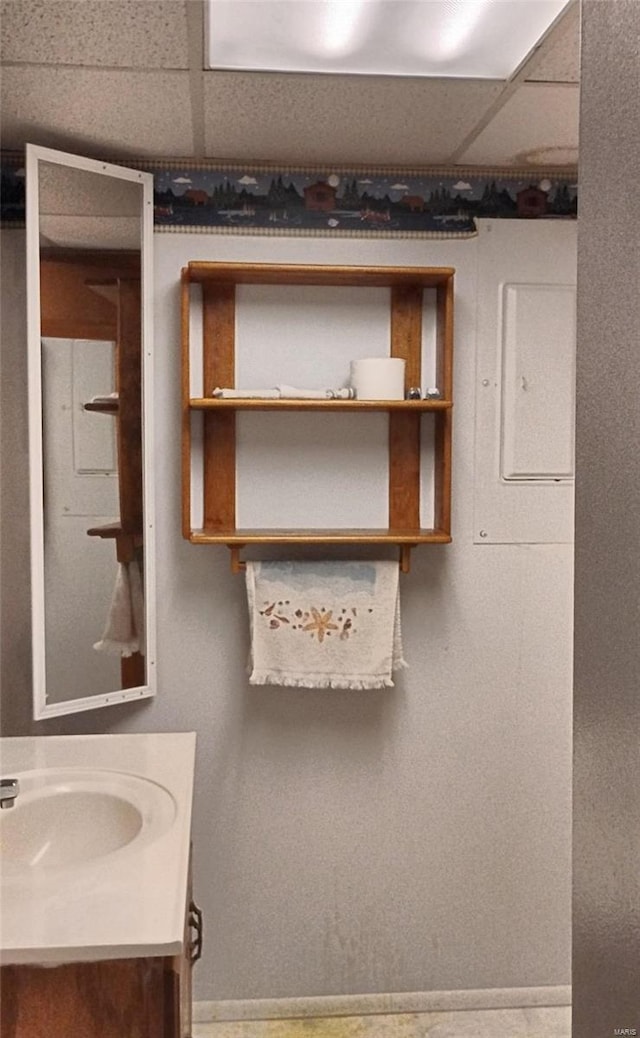 bathroom featuring vanity and a drop ceiling