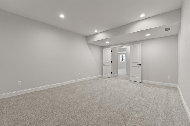 unfurnished room with light colored carpet