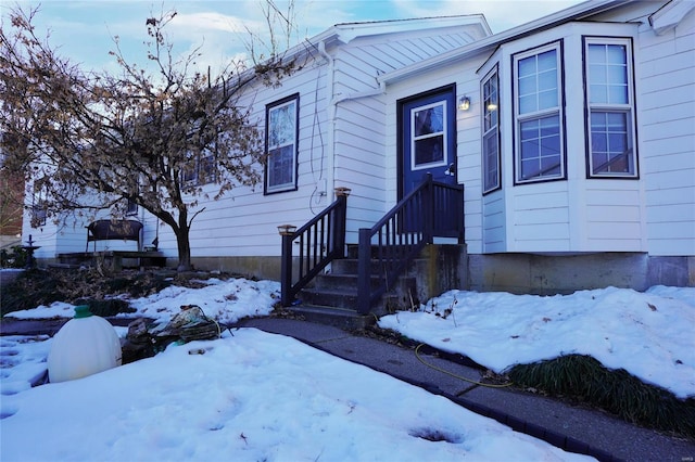 view of snow covered property entrance