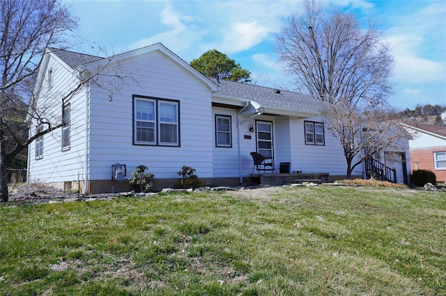 single story home with a front lawn and a shingled roof