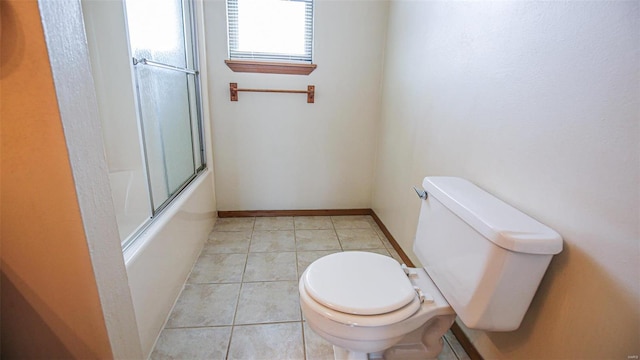 full bathroom with combined bath / shower with glass door, baseboards, tile patterned flooring, and toilet