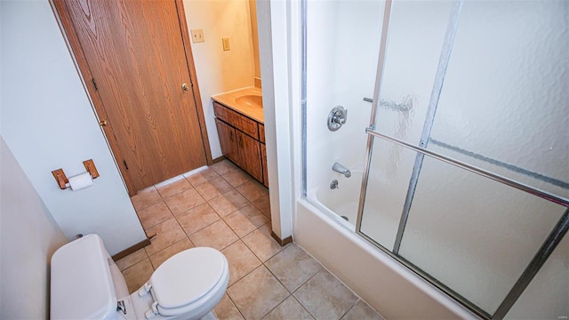 bathroom with enclosed tub / shower combo, tile patterned flooring, vanity, and toilet