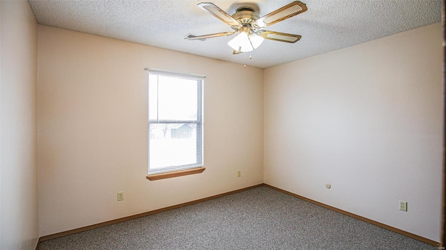 carpeted spare room with baseboards, a textured ceiling, and ceiling fan