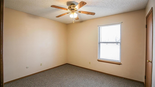 carpeted spare room featuring a textured ceiling, baseboards, and ceiling fan