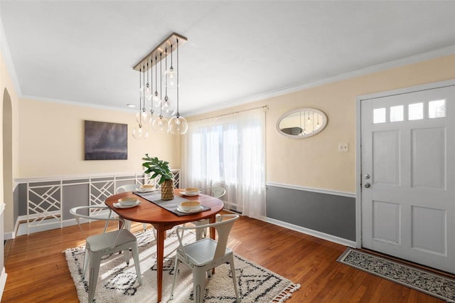 dining area featuring crown molding and wood-type flooring