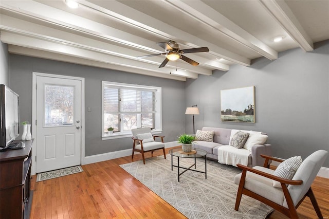 living room with beamed ceiling, ceiling fan, and light hardwood / wood-style floors