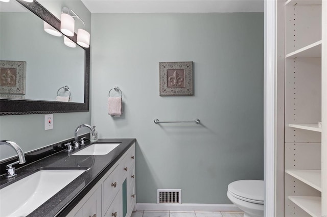 bathroom with tile patterned floors, toilet, and vanity