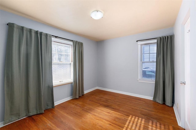 spare room with hardwood / wood-style flooring