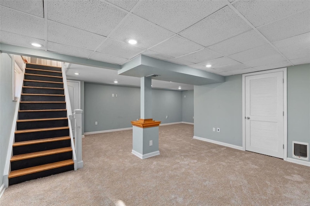 basement with carpet floors and a drop ceiling