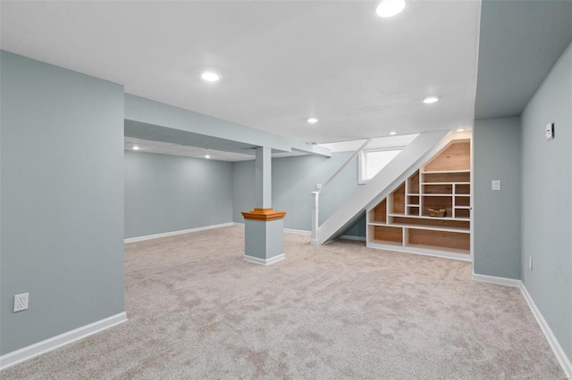 basement featuring light colored carpet