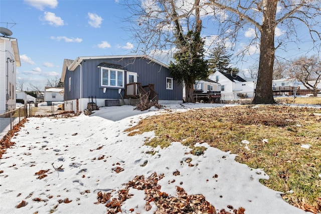 view of snow covered back of property