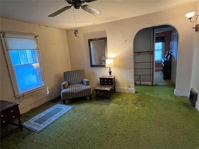 sitting room with ceiling fan and carpet flooring