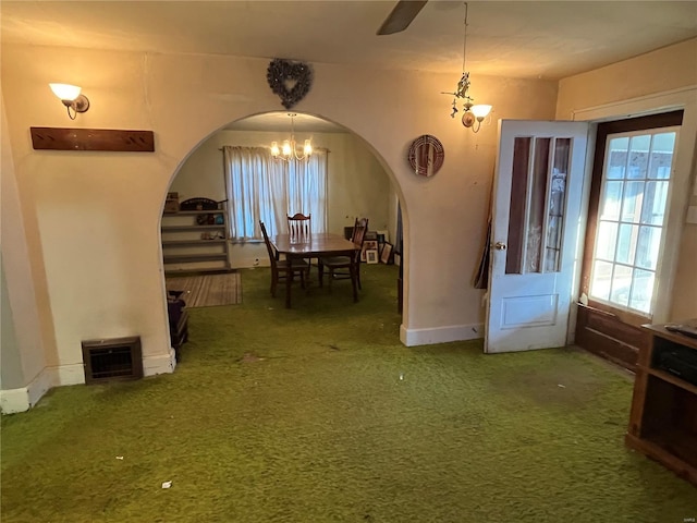 dining room featuring carpet and a notable chandelier