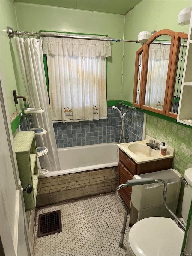 full bathroom featuring shower / tub combo with curtain, vanity, toilet, and tile patterned flooring