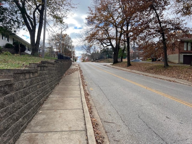 view of road with curbs and sidewalks