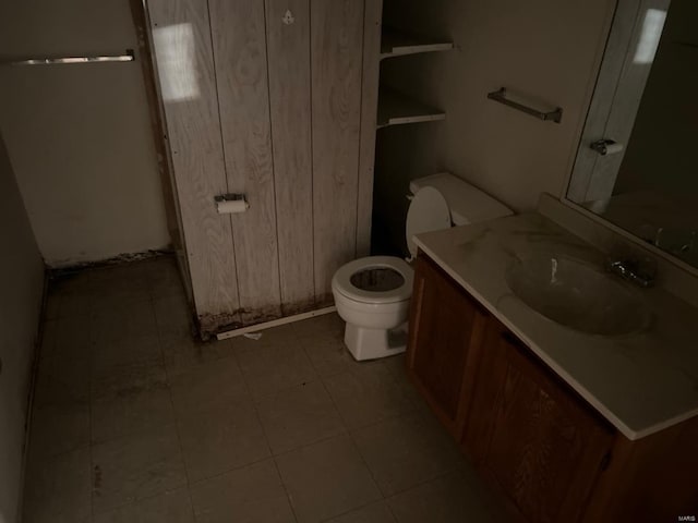 bathroom with vanity, toilet, and tile patterned floors