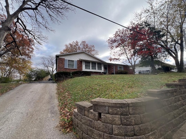 single story home with brick siding and a front lawn