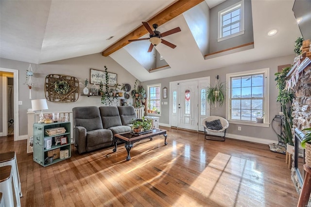 living room with hardwood / wood-style flooring, ceiling fan, and lofted ceiling with beams