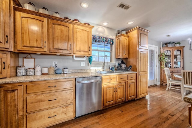 kitchen featuring hardwood / wood-style flooring, dishwasher, and sink