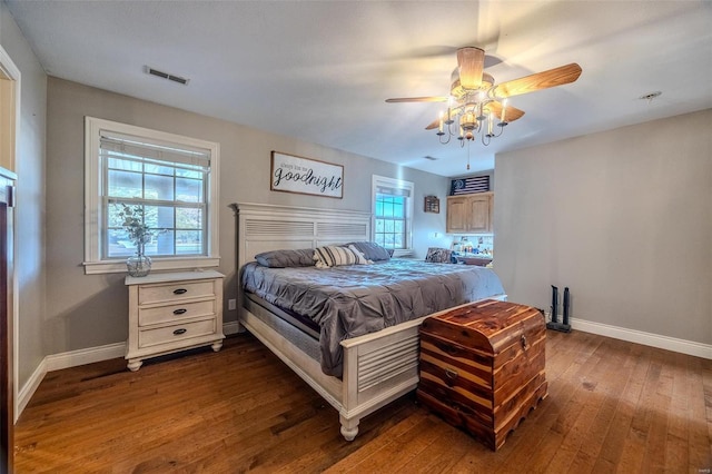 bedroom with dark hardwood / wood-style flooring, multiple windows, and ceiling fan