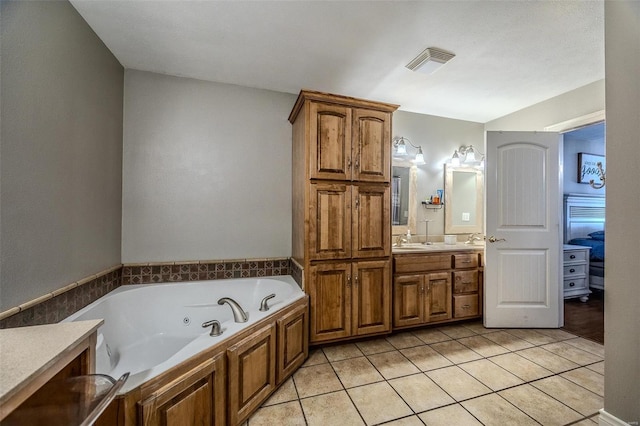 bathroom featuring vanity, a bathtub, and tile patterned flooring