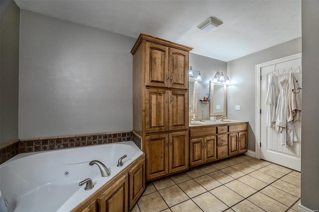 bathroom featuring vanity, tile patterned flooring, and a bathtub