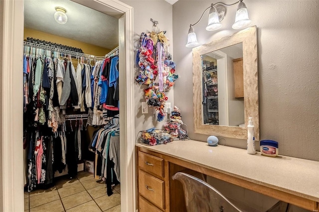 spacious closet with light tile patterned flooring