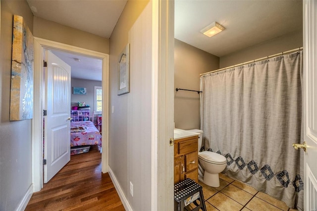 bathroom featuring vanity, curtained shower, and toilet