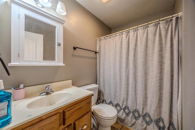 bathroom featuring vanity, a shower with curtain, and toilet