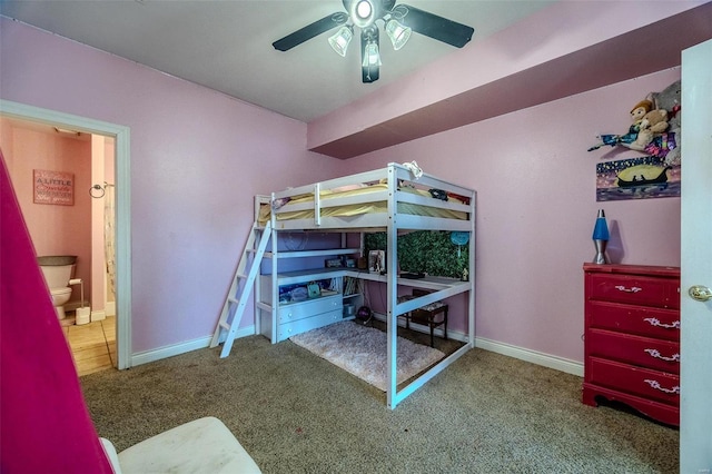 bedroom with ensuite bath, ceiling fan, and carpet flooring