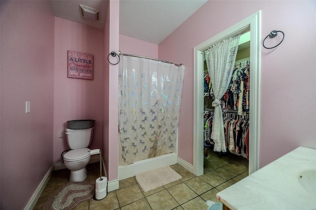 bathroom with tile patterned flooring, vanity, curtained shower, and toilet