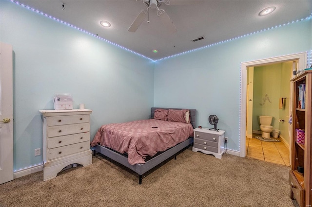 bedroom with ensuite bath, carpet floors, and ceiling fan