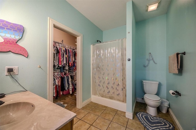 bathroom featuring toilet, vanity, tile patterned floors, and a shower with shower curtain