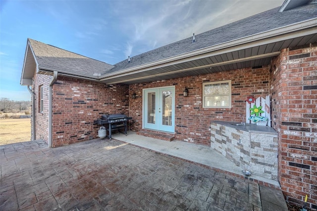 view of patio / terrace with area for grilling and french doors