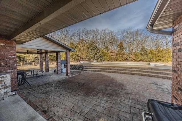 view of patio featuring ceiling fan and a jacuzzi