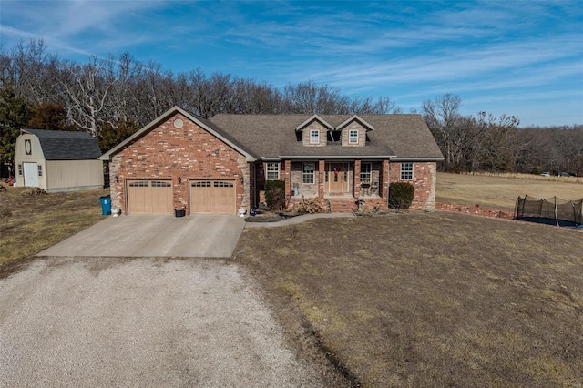 view of front of home with a porch, a storage unit, and a front lawn